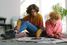 Young focused artists working together with sketches